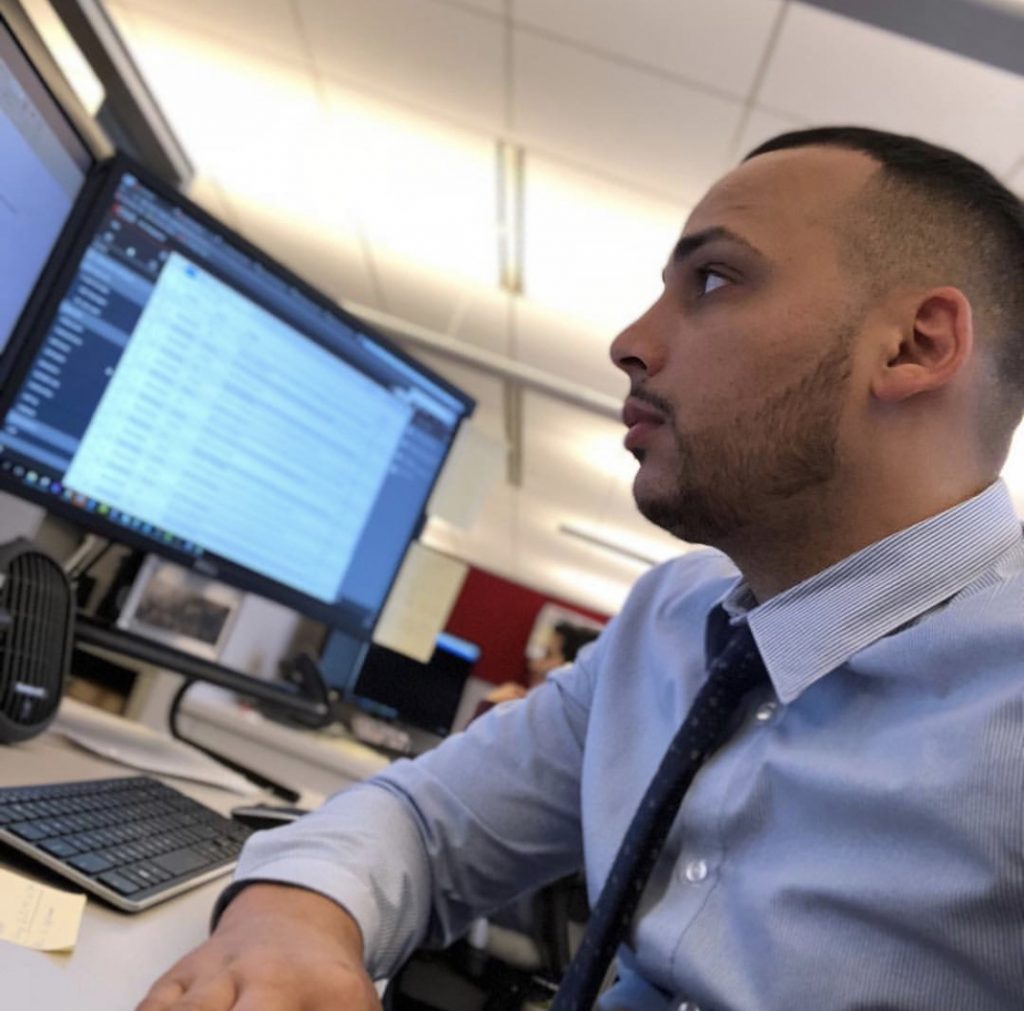 Chris Tejeda working at a multi-monitor workstation